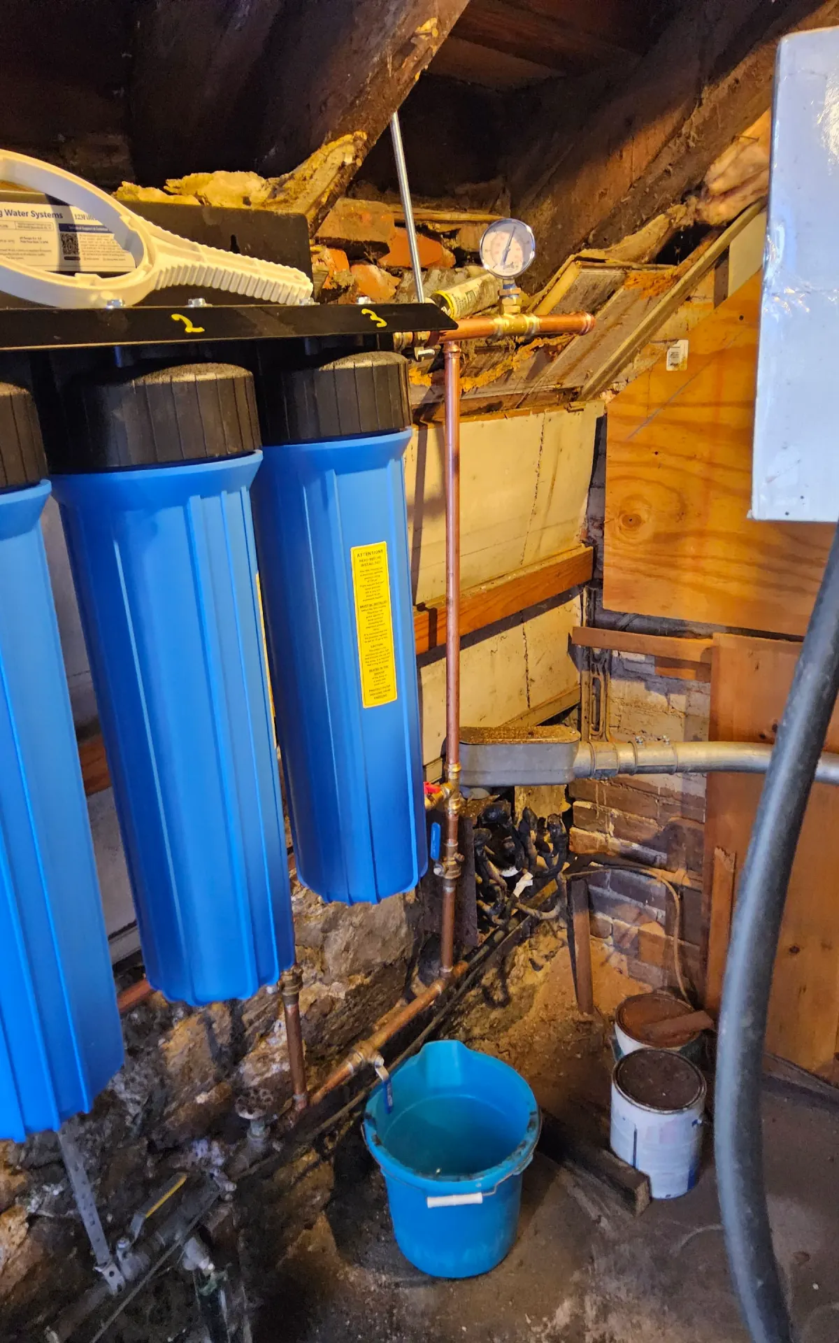 Water softener and water treatment equipment with connected plumbing and filtration components in a Lancaster home.