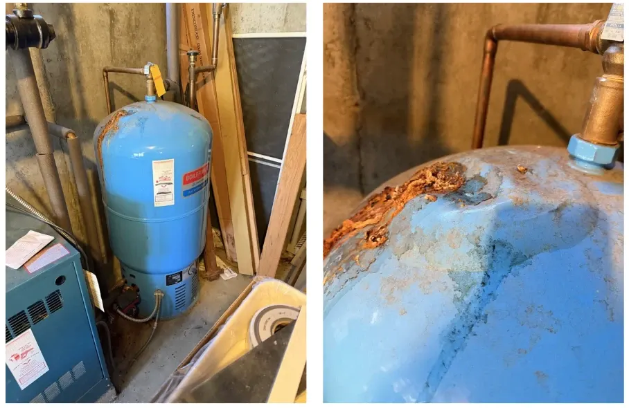 An aging indirect hot water tank with severe rust, corrosion, and visible deterioration around the upper fittings, shown alongside the existing boiler system in a Westford, MA home.